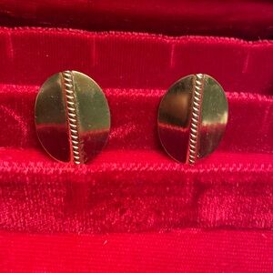 Large gold tone metallic earrings